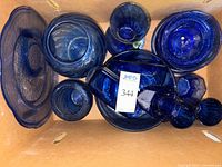 Top view of assorted cobalt blue glassware inside box