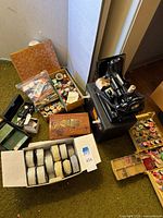 Lot overview showing Singer machine, case, accessory boxes, threads, beaded trim