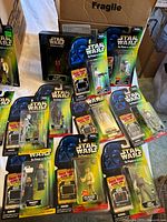 Carded Power of the Force figures spread on table