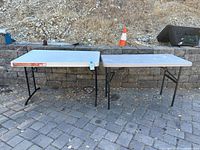 Both folding tables fully assembled side by side