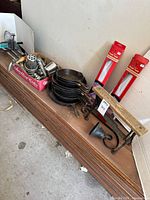 Overall lot showing boxed grinder parts, stacked skillets, boxed food tents, paper dispenser