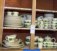 Cabinet view of stacked plates, bowls, cups, accessories