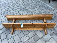 Two wooden shelves laid on paving; shows overall design and finishes
