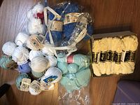 Lot overview with box of crochet cotton and assorted yarn balls
