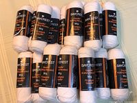 15 skeins of Baycrest Sayelle white yarn stacked