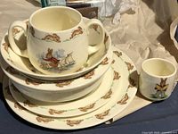 Stacked view showing mug, bowl, two plates, and egg cup