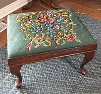 Full view of embroidered footstool