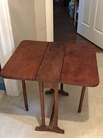 Table fully opened showing drop leaves and legs