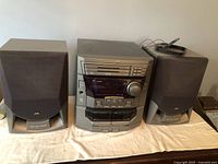 Front view showing main unit and both speakers