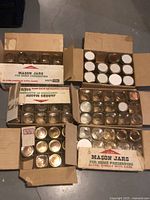 Six cardboard boxes containing mason jars