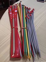 Knitting needles bundled together showing colours, packaging and end caps