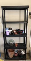 Full view of five-tier black plastic shelf