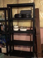 Full view of tall black plastic shelf showing five tiers