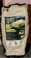 Front view of beige Woods BYO Bed carry bag displaying product label