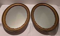 Front view of both matching oval mirrors