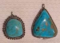 Both pendants side by side on fabric background
