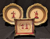 Front view of all three framed petit-point embroideries