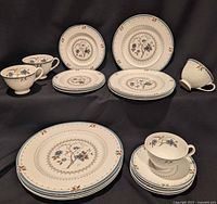 Entire 20-piece set arranged: dinner, salad, dessert plates, cups, saucers