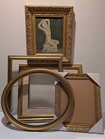 All five gold-toned frames, one holding signed nude oil painting