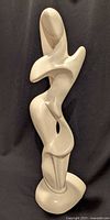 Front view of full ceramic sculpture showing abstract woman and dog
