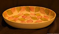 Full view of oval dish showing leaf pattern and depth