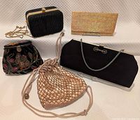 Group shot of four evening bags and wallet