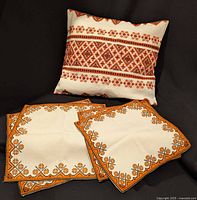 Front view of cushion cover with three table toppers displayed