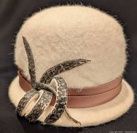 Front left view showing bead applique and ribbon band