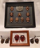 Overall lot showing large framed set, small framed set, and four loose masks