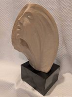 Front three-quarter view of sculpture on base