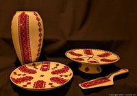 Group view of vase, plate, cake stand and server showing pattern and scale