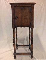 Full view of wooden side table with door closed