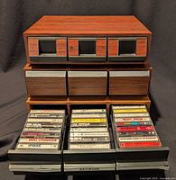Front view of three storage boxes, drawers open showing tapes