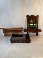 Group shot of shelf, mirror with shelf, and display case