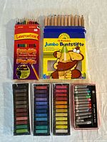 Assorted coloured pencil and pastel sets displayed