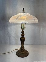 Full view of lamp lit with shade attached