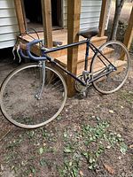 Full view of Bianchi purple road bike leaning against steps