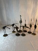 Group shot of all eight brass bird figurines