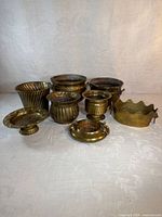 Group of eight brass vessels arranged together
