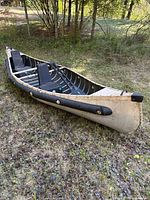 Side view of Sportspal aluminum canoe with seats and oars inside
