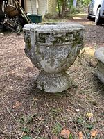 Side view of pedestal urn planter with Greek key pattern