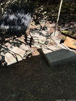 Stack of rectangular and square concrete patio stones in outdoor setting