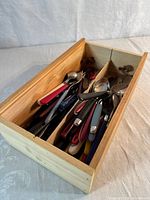 Cutlery mixed in wooden box
