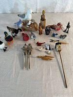 Full lot overview showing figurines, wind chime and pins