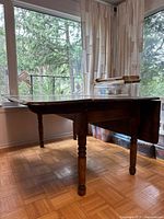 Side view showing both leaves, legs, surrounding windows