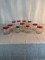 Group view of all 13 glass bear jars with lids