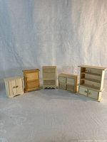 Five unfinished wood furniture pieces lined up