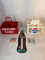 Overview of two plastic beverage crates and bottle flashlight