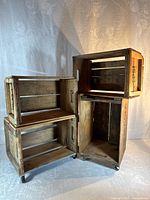 Four stacked wooden Pepsi crates, two on wheels
