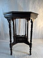 Full view of octagonal side table showing top, legs, and overall design